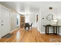 Inviting dining room featuring hardwood floors, a modern light fixture, and updated decor at 1202 9Th Ave, Longmont, CO 80501