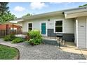 Close-up of the home's facade showing the cozy front porch and landscaped garden at 1202 9Th Ave, Longmont, CO 80501