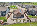 Aerial view of a single-story house with a fenced backyard and solar panels on the roof at 1297 Black Haw St, Elizabeth, CO 80107