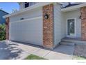 Home exterior featuring a two-car garage with brick pillars and a well-maintained front yard at 13382 Franklin St, Thornton, CO 80241