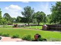 Expansive backyard with mature trees, playhouse, and views of the adjacent park and tennis courts at 1380 Holly E Dr, Broomfield, CO 80020