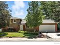 Charming home with a well-maintained lawn, mature trees, and a two-car garage at 1380 Holly E Dr, Broomfield, CO 80020