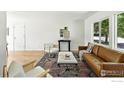 Bright living room with a leather couch, stylish chairs, and a beautiful rug at 1380 Holly E Dr, Broomfield, CO 80020