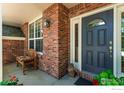 Close-up view of the front porch showcasing brick details and a well-designed entrance at 13951 Brookside Ct, Broomfield, CO 80023