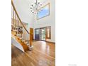 Spacious foyer with hardwood floors, high ceilings, statement lighting, and staircase at 14601 Akron St, Brighton, CO 80602