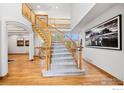 Elegant staircase with carpeted steps and wooden railing, leading to the upper level at 14601 Akron St, Brighton, CO 80602
