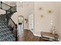 Entryway with staircase, hardwood floors, and decor lighting at 1485 Eversole Dr, Broomfield, CO 80023
