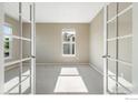 Bright office with neutral carpet and bright sunlight at 17216 E Trailmaster Dr, Parker, CO 80134