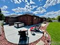 Spacious backyard with patio, hot tub, and cozy seating area for relaxing at 1806 Crestone Ct, Longmont, CO 80504
