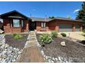 Charming brick home with attached garage, walkway and manicured landscaping at 1806 Crestone Ct, Longmont, CO 80504