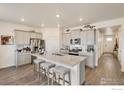 Bright kitchen with stainless steel appliances, granite countertops, and a large center island with seating at 1885 Mount Monroe Dr, Berthoud, CO 80513