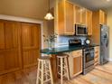 Cozy kitchen with stainless steel appliances, ample cabinet space, and a breakfast bar at 2204 Pine St, Boulder, CO 80302