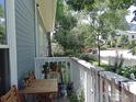 Relaxing back porch with wooden furniture, offering a private outdoor retreat with scenic views at 2205 Arapahoe Ave # 3, Boulder, CO 80302