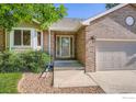 Close-up showcasing brick facade, well-kept landscaping, and the attached two-car garage at 2615 Falcon Dr, Longmont, CO 80503