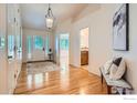 Inviting foyer with hardwood floors, decorative lighting, and access to living areas at 2615 Falcon Dr, Longmont, CO 80503