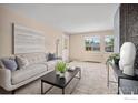 Inviting living room with bright neutral walls, carpet, contemporary decor, and a large window at 3009 Madison Ave # 317, Boulder, CO 80303