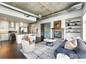 Spacious open-concept living area with fireplace, kitchen, and stylish furnishings at 3401 Arapahoe Ave # 420, Boulder, CO 80303