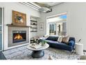 Bright living room featuring a cozy fireplace, stylish decor, and comfortable seating at 3401 Arapahoe Ave # 420, Boulder, CO 80303