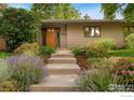 Charming single-story home featuring a well-manicured front yard and inviting curb appeal at 4160 Caddo Pkwy, Boulder, CO 80303
