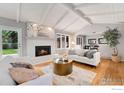 Bright living room features a cozy fireplace, vaulted ceilings, and hardwood floors at 4160 Caddo Pkwy, Boulder, CO 80303