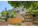 Charming townhome exterior with neatly arranged mailboxes and a decorative wooden fence at 4717 Tantra Dr # G, Boulder, CO 80305