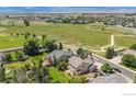 Aerial view of a home and its surrounding neighborhood, showcasing proximity to green spaces at 4804 Kingbird Dr, Frederick, CO 80504