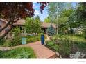 Beautiful home showcasing lush landscaping, brick walkway, and mature trees creating a welcoming outdoor space at 4832 Silver Sage Ct, Boulder, CO 80301
