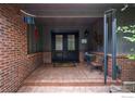 Inviting brick front porch featuring double doors with decorative glass and decorative windchimes on a brick wall at 4832 Silver Sage Ct, Boulder, CO 80301