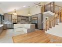 Spacious kitchen with modern cabinets, stainless steel appliances, tiled backsplash, and hardwood floors at 515 W Fir Way, Louisville, CO 80027