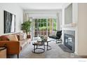 Bright living room with modern fireplace, stylish furniture, and sliding glass doors to the outside at 530 Mohawk Dr # 73, Boulder, CO 80303
