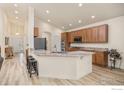 Spacious open kitchen with granite countertops, wood floors, large island, and stainless steel appliances at 6324 Saratoga Trl, Erie, CO 80516