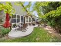 Patio featuring outdoor dining and lounge seating, complemented by a well-manicured lawn and fire pit at 6324 Saratoga Trl, Erie, CO 80516