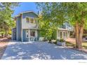 The home's exterior has a well-manicured lawn, driveway, and mature trees at 725 Union Ave, Boulder, CO 80304