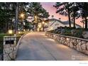 Long, private driveway leads to an elegant home with stone accents and professional landscaping at 90 Hawk Ln, Boulder, CO 80304