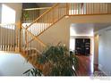 Elegant wooden staircase with a view of the living area below at 12609 Jersey W Cir, Thornton, CO 80602