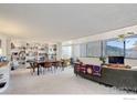 Bright living room boasts large windows, a built-in bookcase, and comfortable seating area at 1850 Folsom St # 706, Boulder, CO 80302