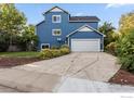 Two story home with a concrete driveway leading to an attached two car garage at 1993 S Fork Dr, Lafayette, CO 80026