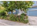 Charming home with a front yard that features an oversized shade tree and beautiful landscaping at 1993 S Fork Dr, Lafayette, CO 80026