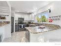 Bright kitchen with stainless steel appliances, granite countertops and a large window overlooking greenery at 1993 S Fork Dr, Lafayette, CO 80026