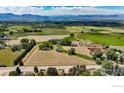 Aerial view showcases sprawling land, lush fields, and serene mountain backdrop at 2221 N 95Th St, Boulder, CO 80301
