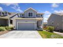 View of a two-story home with neutral siding and an attached two-car garage at 2742 Cooperland Blvd, Berthoud, CO 80513