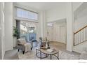 Open floor plan living room with high ceilings and access to a patio at 4108 Riley Dr, Longmont, CO 80503
