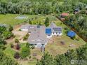 Aerial view of a well maintained home with mature landscaping, solar panels, and various backyard amenities at 4223 Eldorado Springs Dr, Boulder, CO 80303