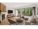 Bright living room featuring a fireplace and sliding glass doors to the outdoor space at 4627 Burgundy Ln, Boulder, CO 80301