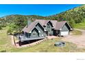 Beautiful home with a sprawling lawn, deck, and charming details on a sunny day at 4815 Sugarloaf Rd, Boulder, CO 80302