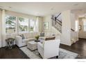 Bright living room showcasing a neutral color palette, hardwood floors, and large windows at 5451 W 73Rd Ave, Westminster, CO 80003