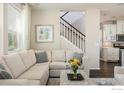 Comfortable living room featuring a staircase, hardwood floors, and lots of natural light at 5451 W 73Rd Ave, Westminster, CO 80003