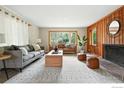 Bright living room featuring large windows, wood accents and stylish decor at 775 Pleasant St, Boulder, CO 80302