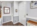 Clean entryway with coat closet and half wall. Table provides decor for entryway at 8321 E 33Rd Ave, Denver, CO 80238