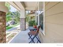 Relaxing front porch with an outdoor chair and table at 8321 E 33Rd Ave, Denver, CO 80238